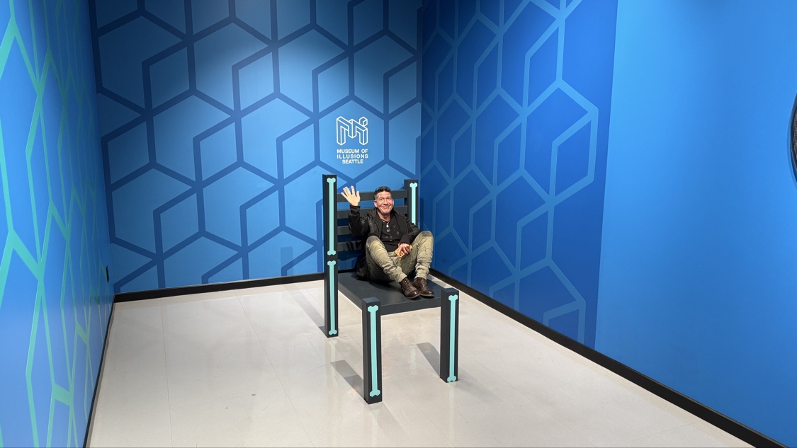 Rob on the giant chair at the Museum of Illusions